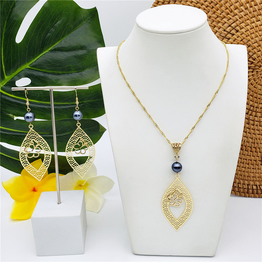 Set Of Carved Waves And Leaf Charm Earrings And Necklace Sustained With A Petrol Pearl And Different Hawaiian Charms