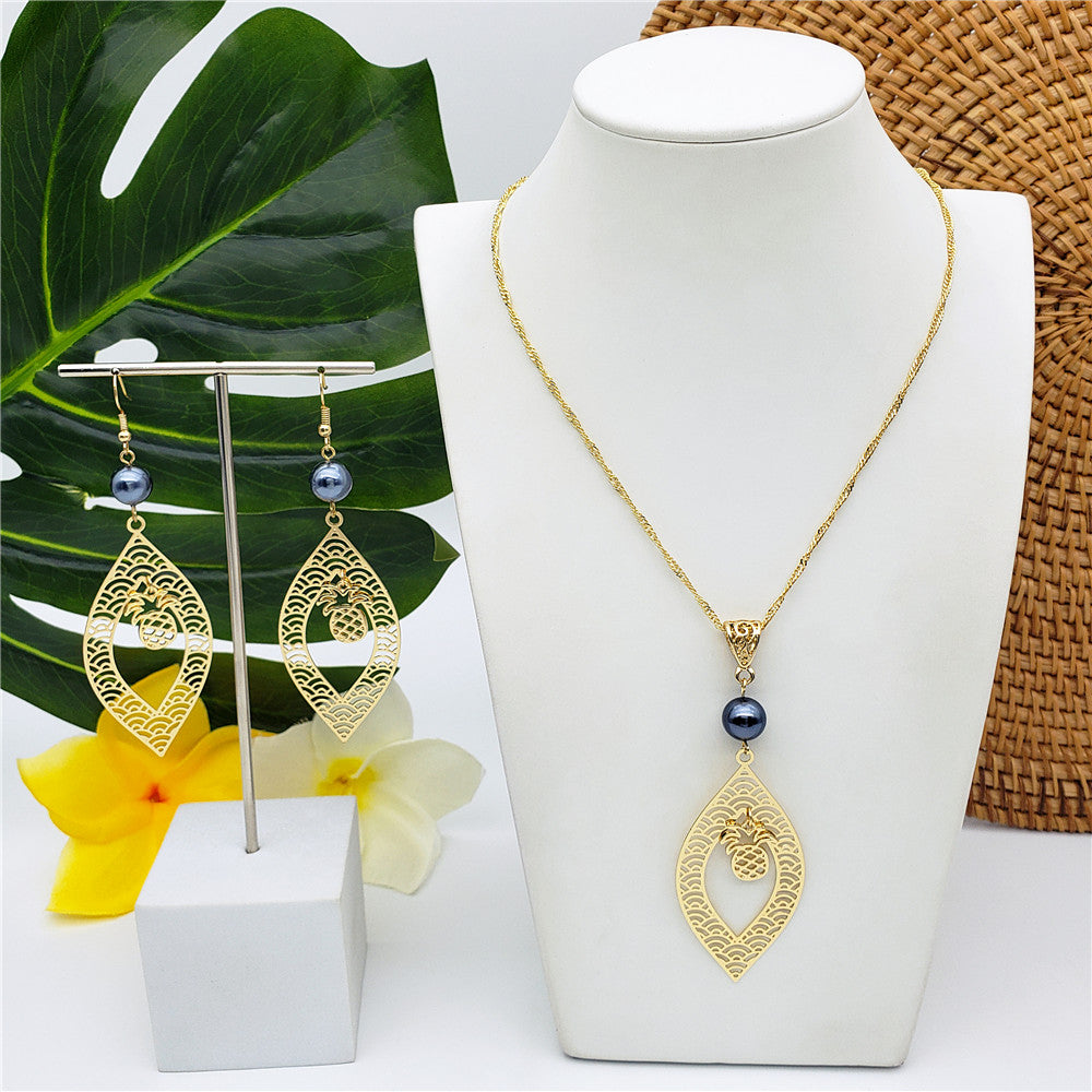 Set Of Carved Waves And Leaf Charm Earrings And Necklace Sustained With A Petrol Pearl And Different Hawaiian Charms