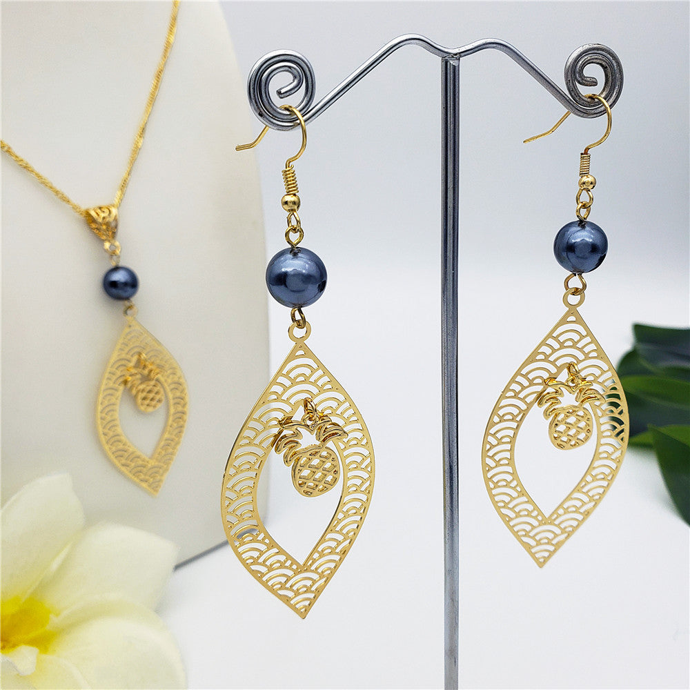 Set Of Carved Waves And Leaf Charm Earrings And Necklace Sustained With A Petrol Pearl And Different Hawaiian Charms