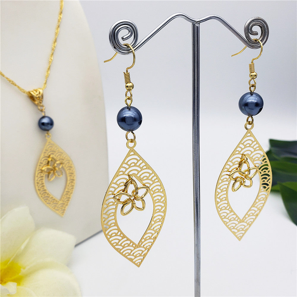 Set Of Carved Waves And Leaf Charm Earrings And Necklace Sustained With A Petrol Pearl And Different Hawaiian Charms