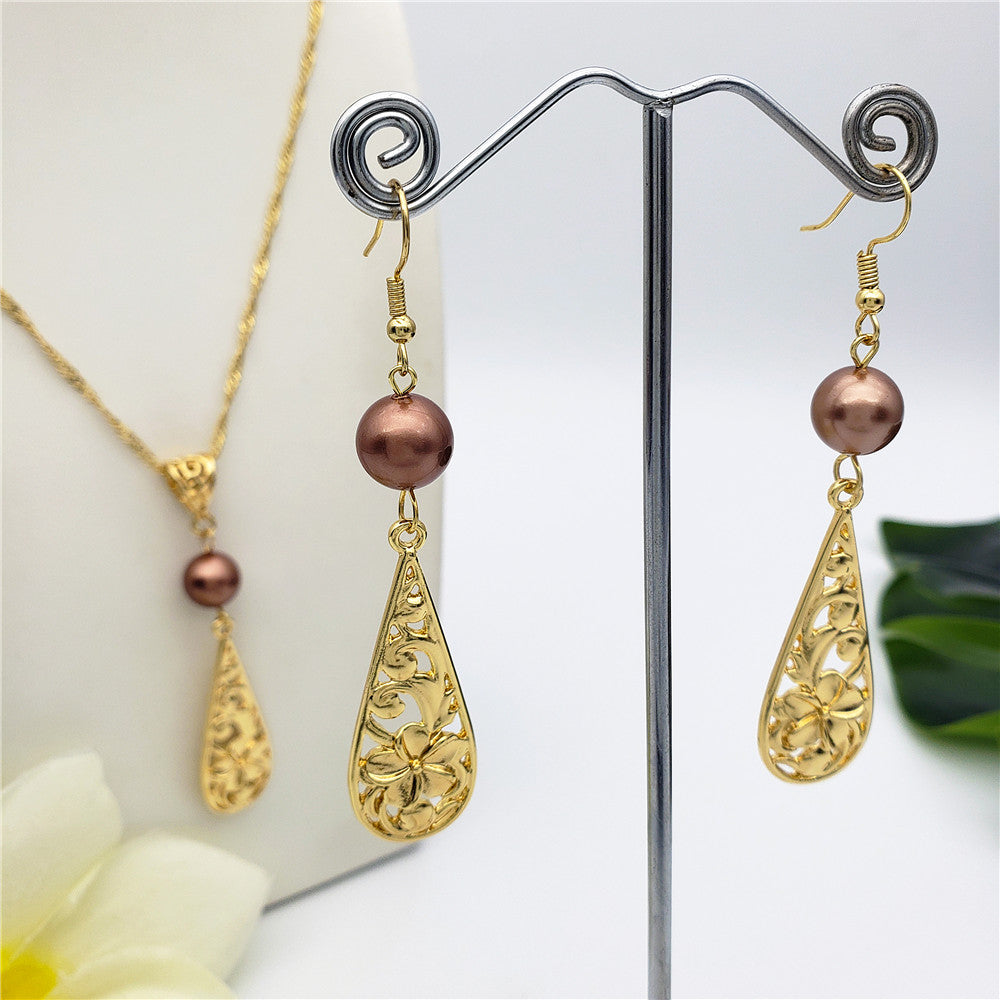 Set Of Carved Plumeria Flower And Leaves Teardrop Earrings And Necklace Sustained With A Pearl In Different Colors